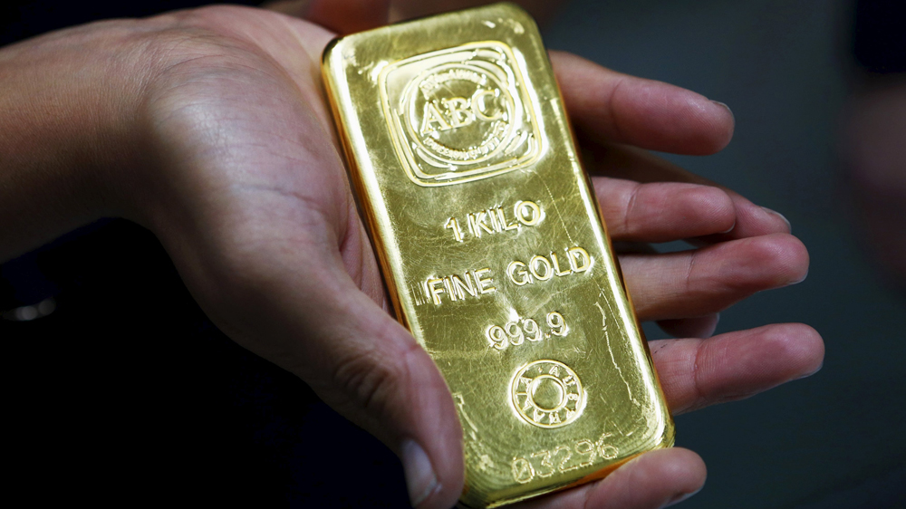 A bullion dealer employee handles a one kilogram bar at a trading house, where counter spreads over the exchange set the silver rate today