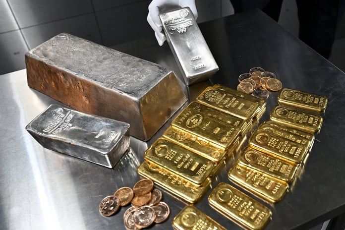 An employee holds a silver bar in a safe deposit room, the metal behind the silver rate today quoted across Indian cities