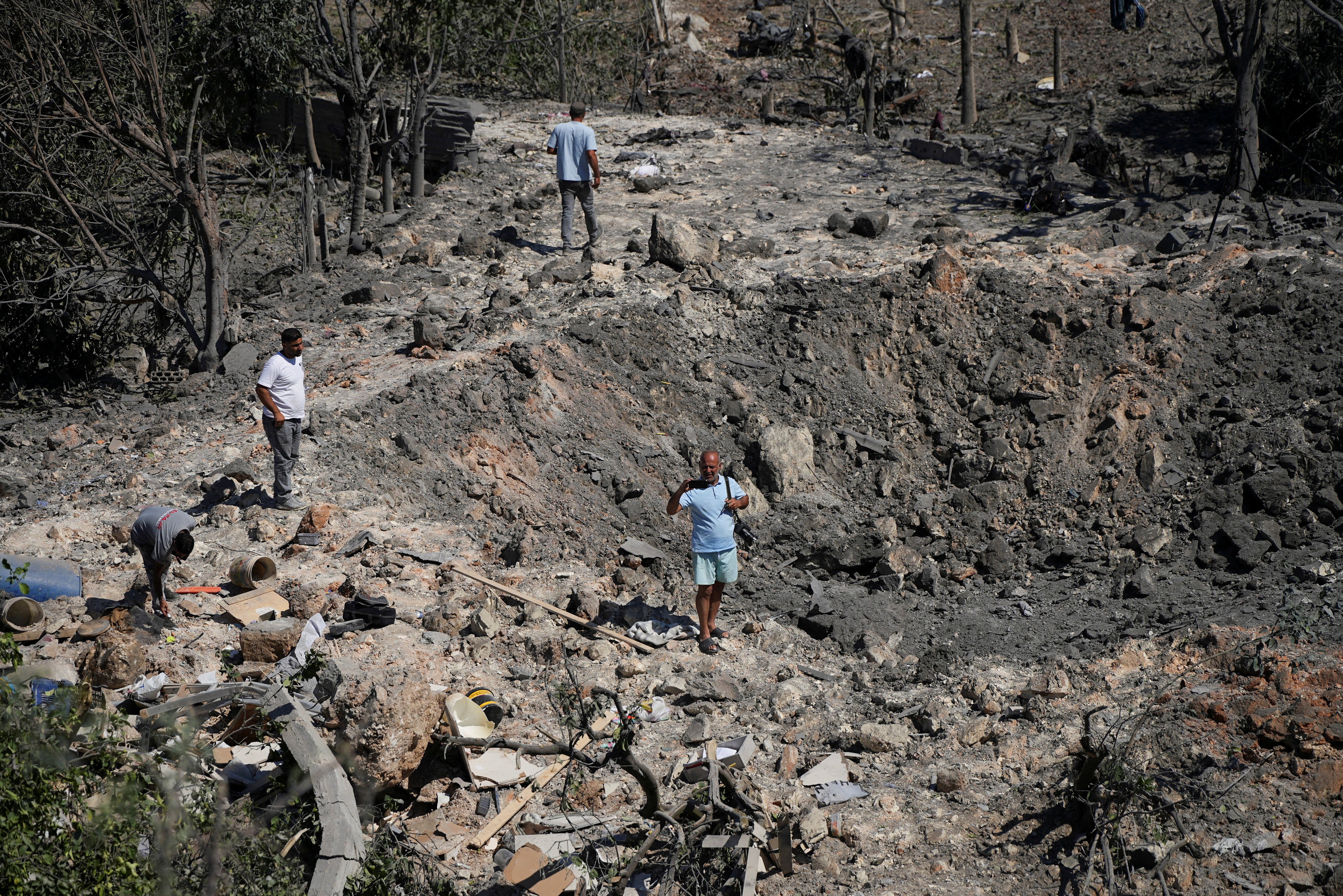 Displaced residents in southern Lebanon amid sustained Israeli military strikes on villages and agricultural land in August 2026