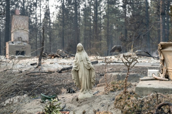 Virgin Mary statue stands amid burned ruins of homes in Spokane Balboa neighborhood after Old Trails Fire August 2026