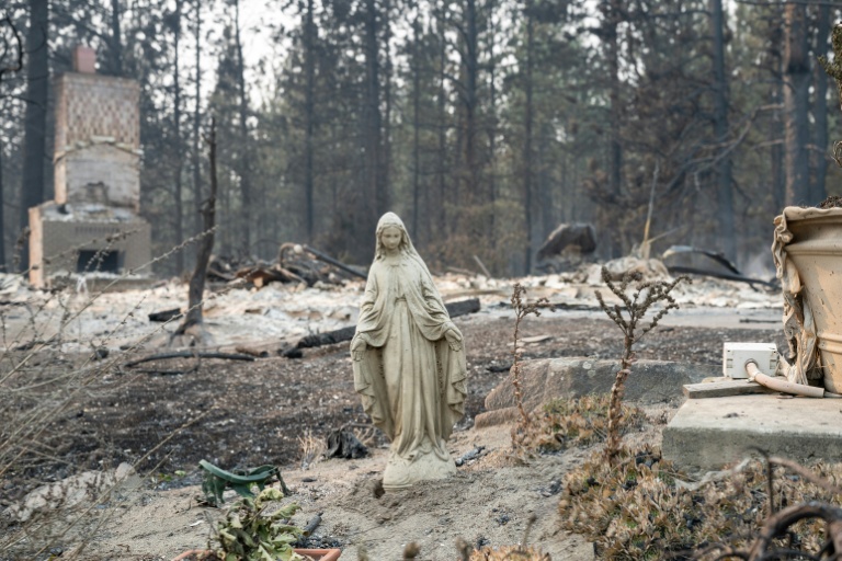 Virgin Mary statue stands amid burned ruins of homes in Spokane Balboa neighborhood after Old Trails Fire August 2026