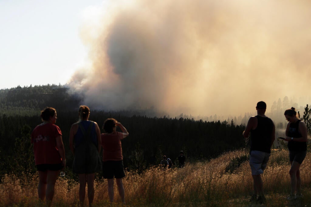 Residents watch the Old Trails Fire burning on Northwest Boulevard in Spokane Washington August 2026