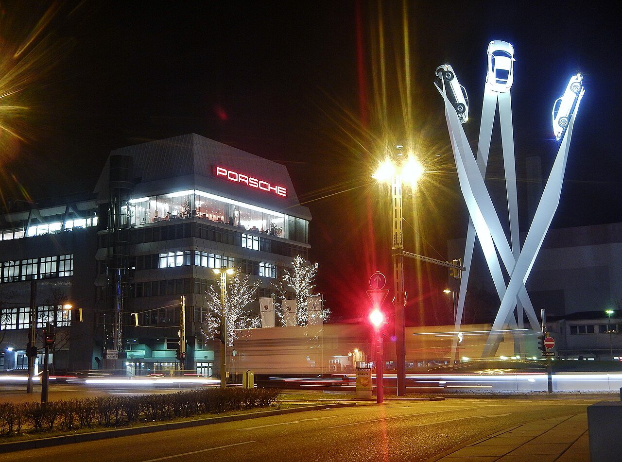 Three white Porsche 911 sculptures rising over the roundabout outside the Porsche works at Zuffenhausen, Stuttgart