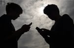 Teenagers using smartphones, illustrating social media addiction lawsuits cleared by the Ninth Circuit