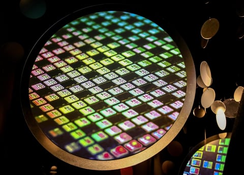 TSMC semiconductor chip wafer displayed at the TSMC Museum of Innovation in Hsinchu Taiwan, showing colorful die patterns
