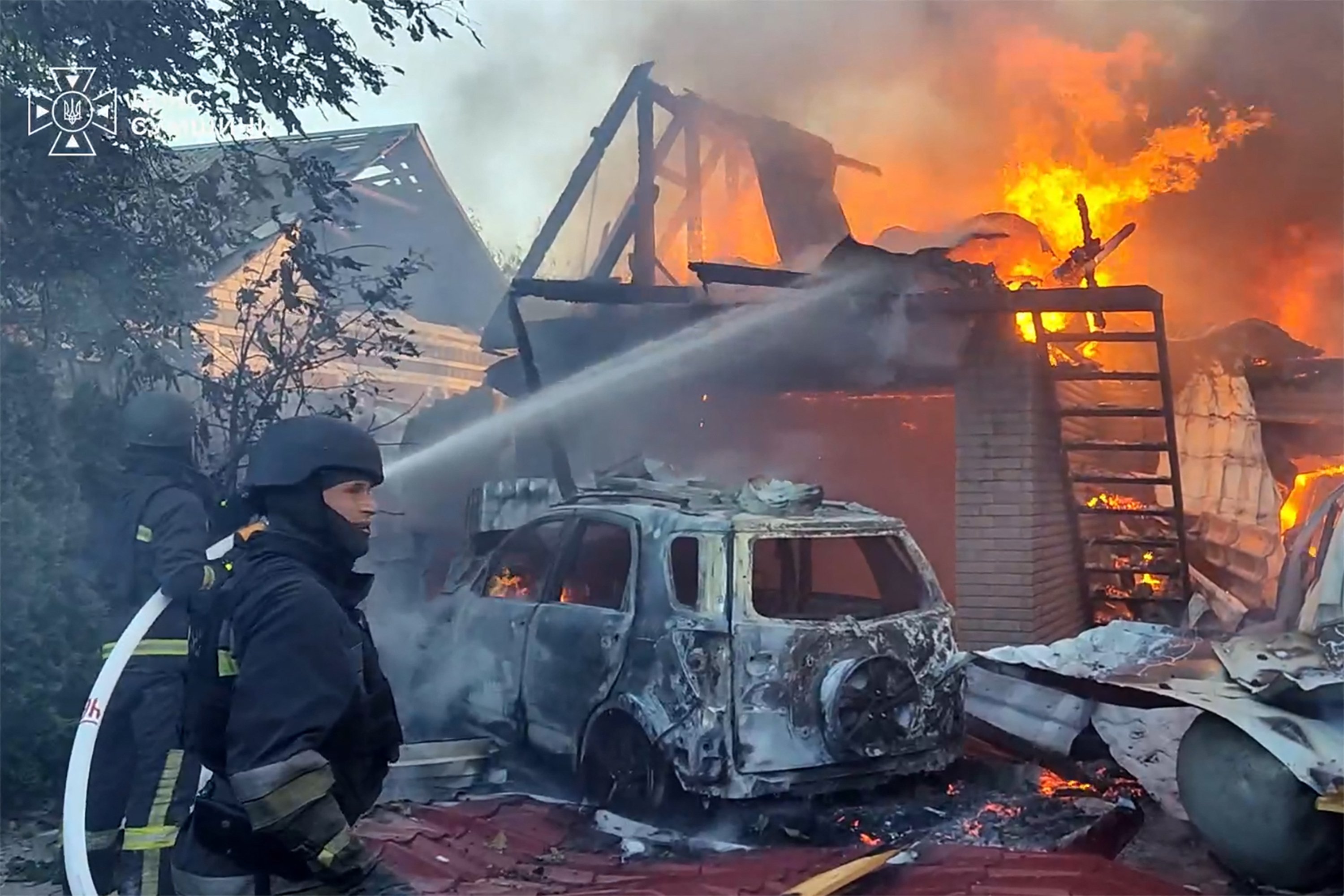 Ukrainian emergency service workers respond to a fire in Sumy region following a Russian air attack, August 2026