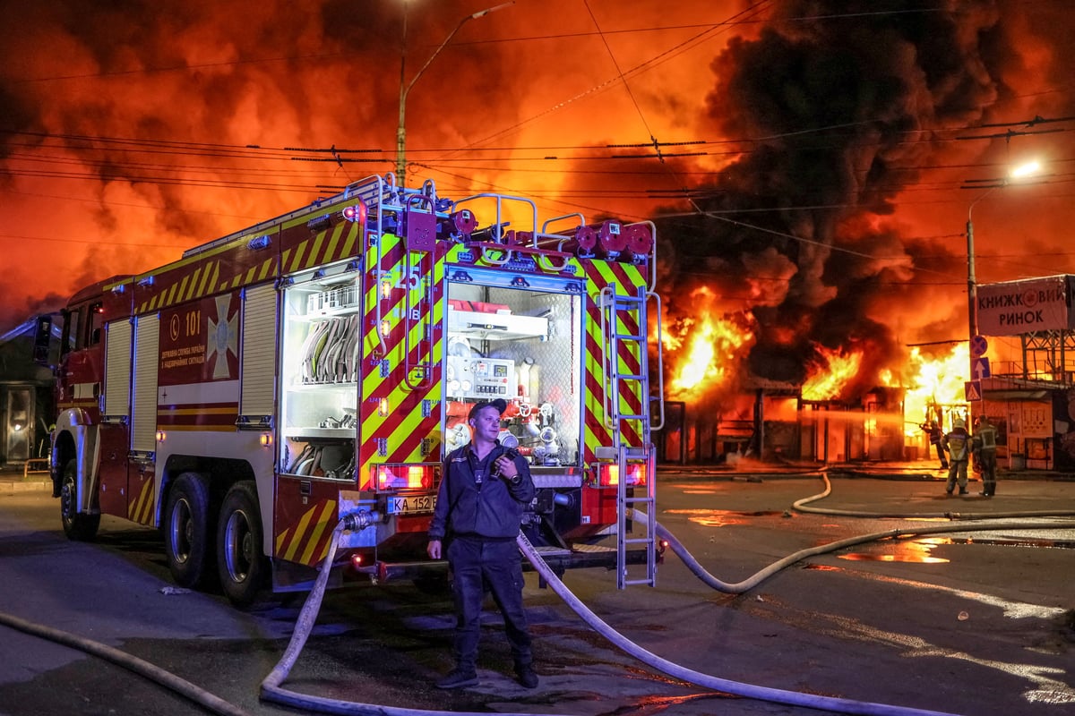 Firefighters work at a Kyiv book market hit by a Russian missile strike on August 16, 2026