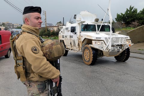 UNIFIL peacekeeping vehicle passing a Lebanese soldier in southern Lebanon amid Israeli strikes
