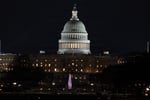 US Capitol building illuminated at night in Washington DC