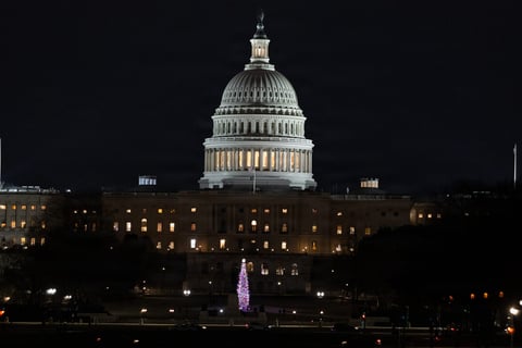 US Capitol building illuminated at night in Washington DC