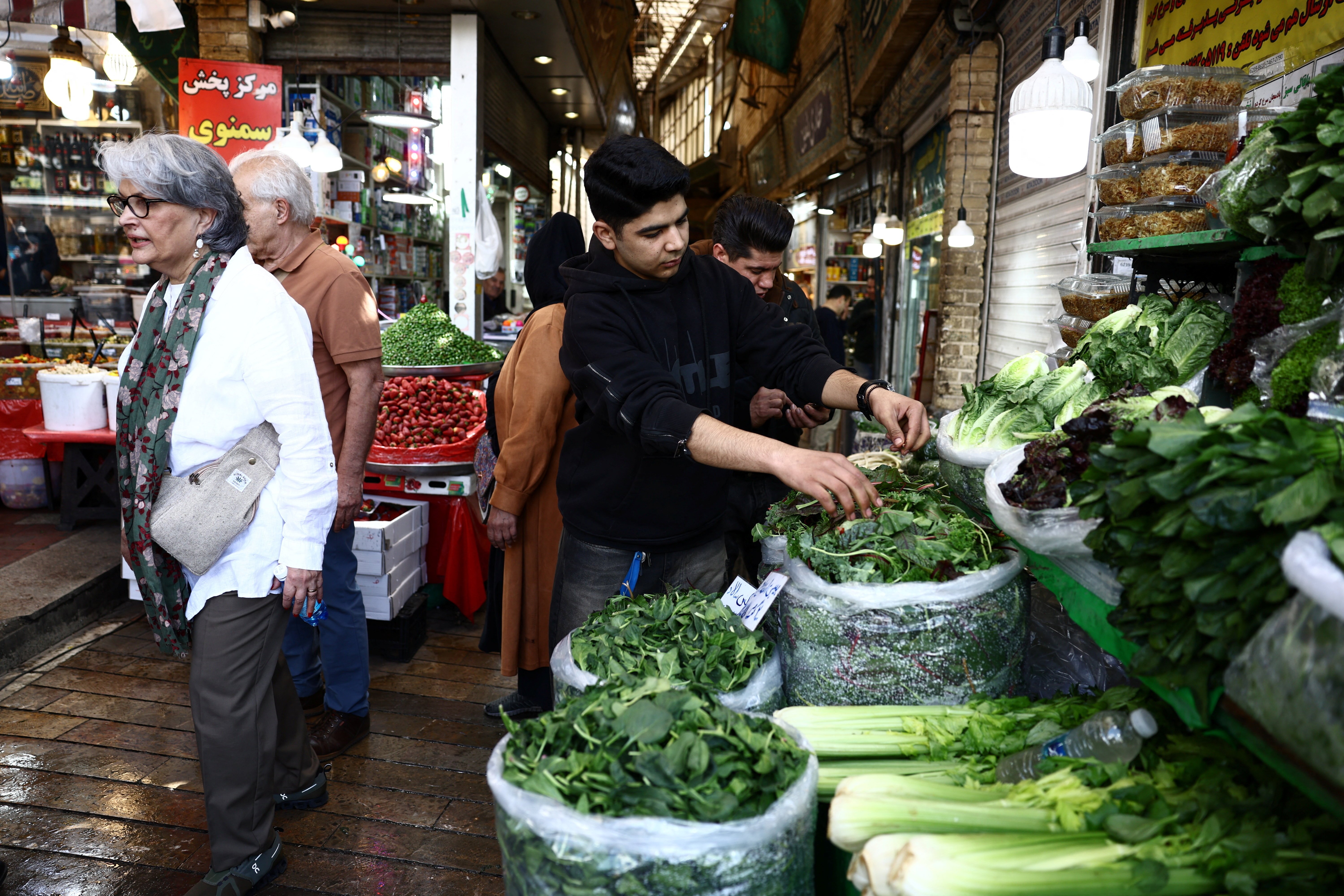 People at a Tehran market as US Iran sanctions under Operation Economic Outcast target the Iranian economy