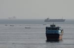 Commercial vessels transiting through the Strait of Hormuz as seen from Musandam peninsula, Oman