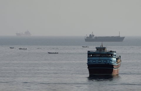 Commercial vessels transiting through the Strait of Hormuz as seen from Musandam peninsula, Oman