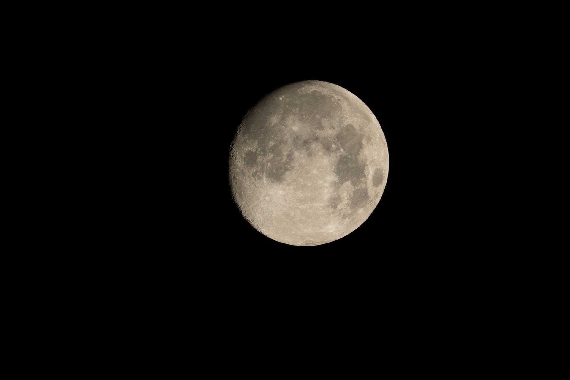 A waxing gibbous moon with the terminator visible along its western limb, the last of the shadow line before the full moon