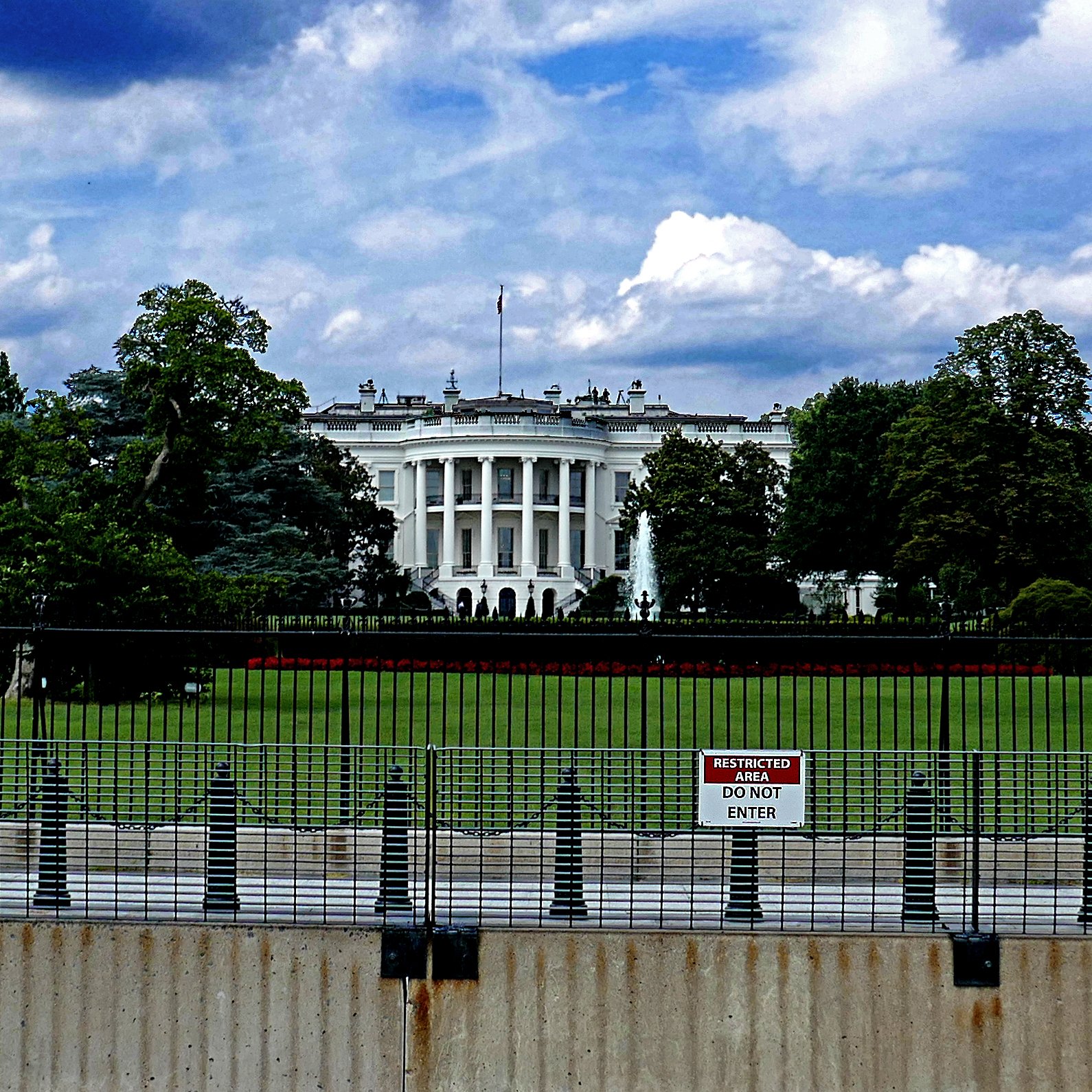 White House behind security fence with Restricted Area Do Not Enter sign, Washington DC