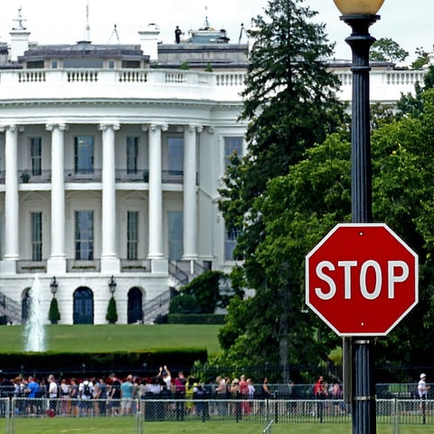 White House exterior with security STOP sign in foreground, Washington DC