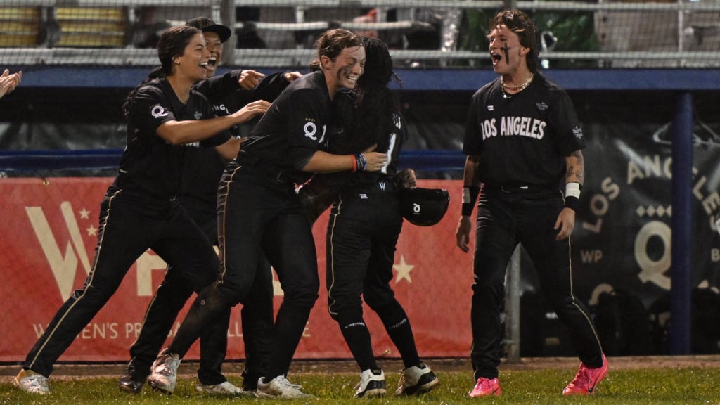 Los Angeles Queens players celebrate their 10-8 comeback victory in the inaugural Women's Professional Baseball League game in Springfield Illinois