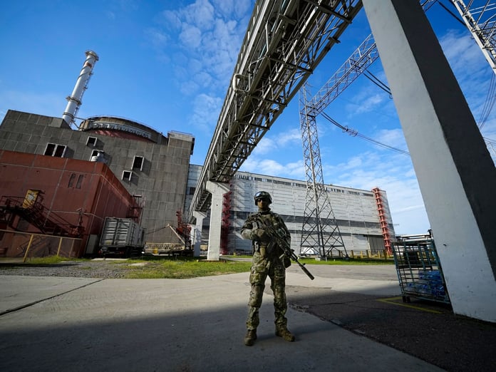 A Russian serviceman stands guard beside a reactor building at the Zaporizhzhia Nuclear Power Plant in Enerhodar, southern Ukraine