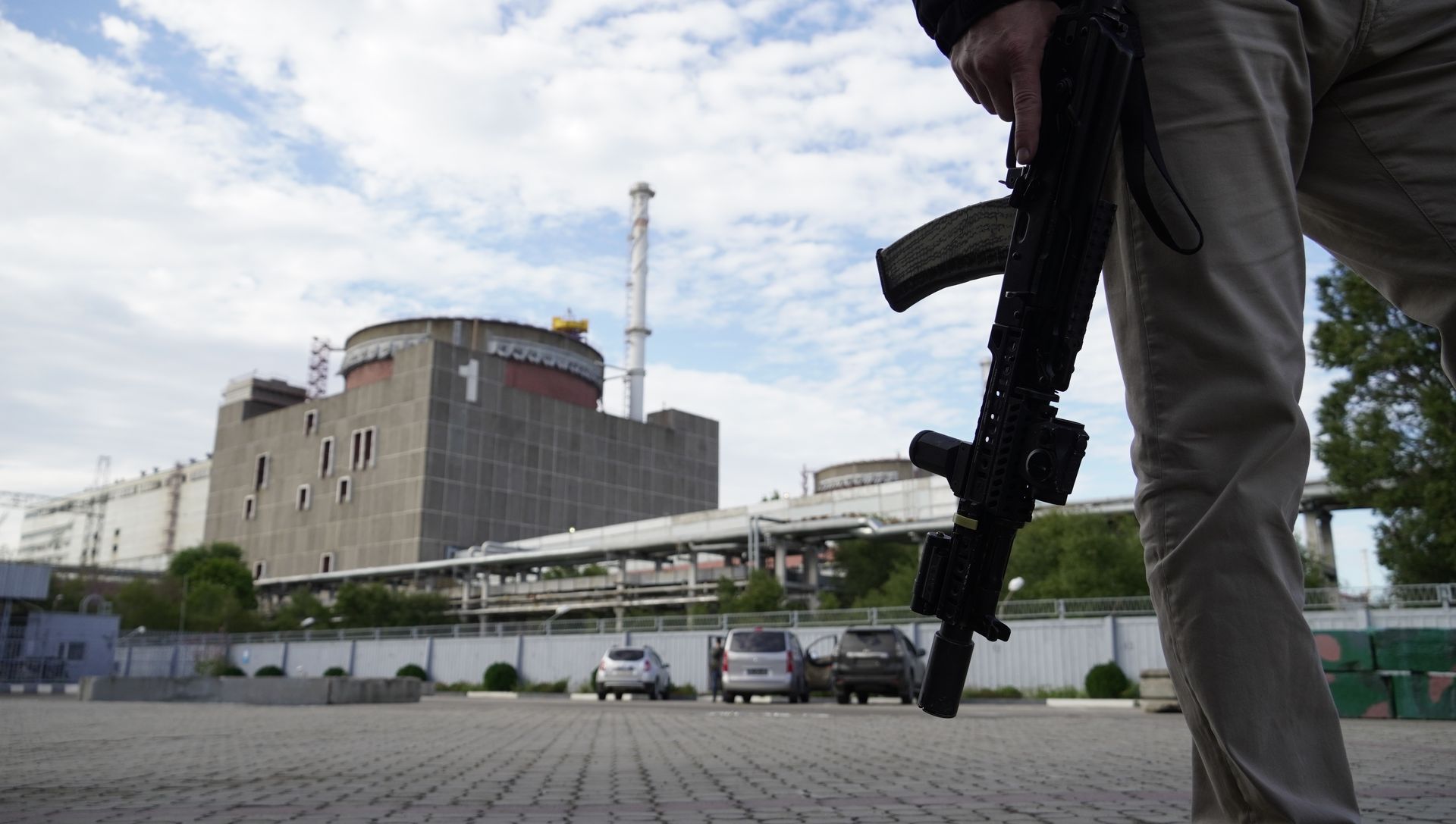 An armed guard carrying a rifle stands outside the Unit 1 reactor building at the Zaporizhzhia Nuclear Power Plant in Enerhodar