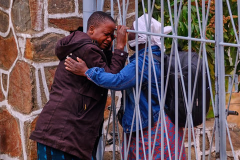 A woman is comforted after losing family members in Zimbabwe's Lake Kariba ferry disaster
