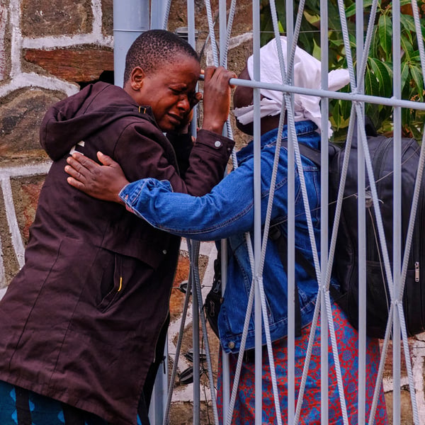 A woman is comforted after losing family members in Zimbabwe's Lake Kariba ferry disaster