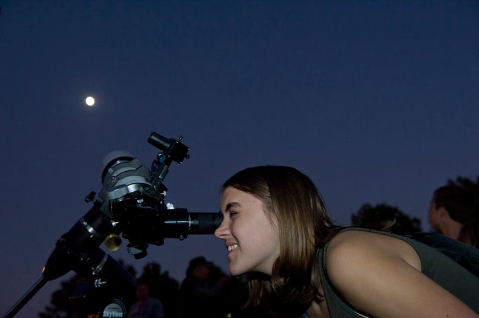 A stargazer observes the night sky, the same celestial backdrop against which the 12 zodiac constellations trace their ancient paths through astrological tradition