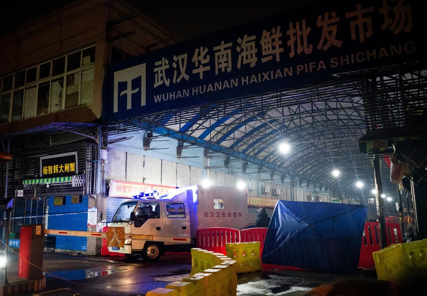 Staff of the Wuhan Hygiene Emergency Response Team leaving the shuttered Huanan Seafood Wholesale Market in Wuhan, China