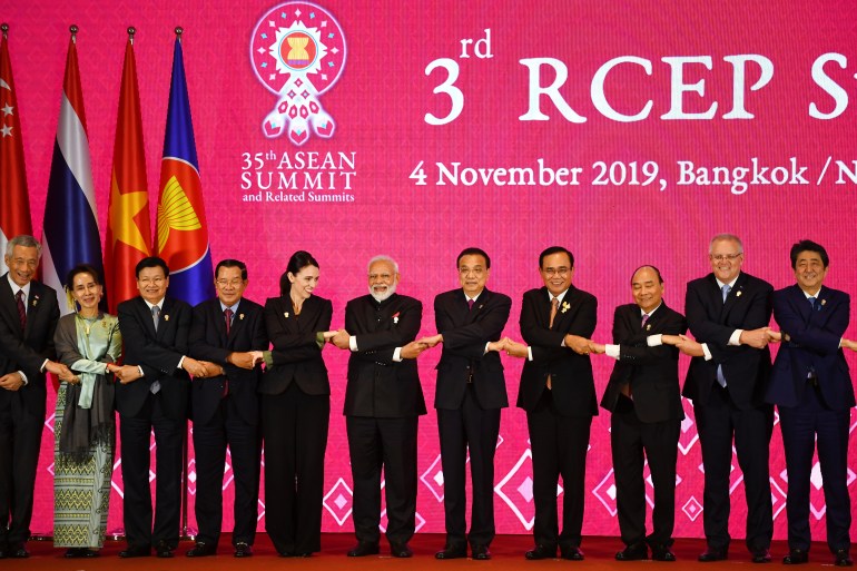 Leaders of RCEP partner countries join hands in the ASEAN cross-arm handshake at the 3rd RCEP Summit during the 35th ASEAN Summit in Bangkok