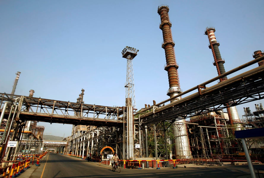 A worker rides a bicycle at Bharat Petroleum Corporation Ltd. refinery in Mumbai