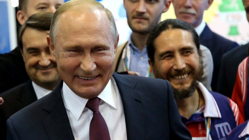 Russian president Vladimir Putin laughing