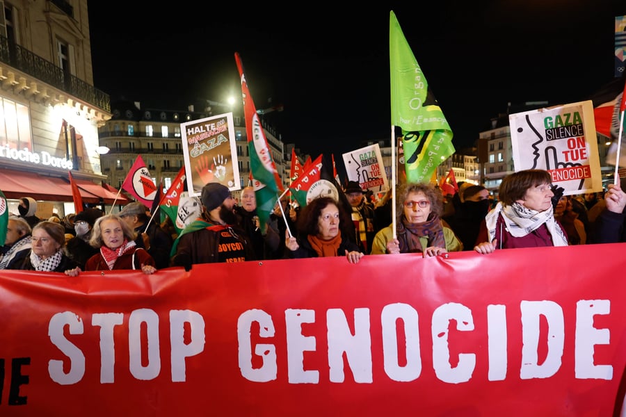 Demonstrators hold a banner reading Stop Genocide during the protests in Paris