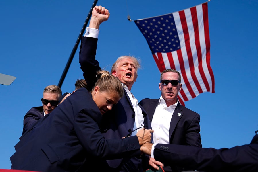 Republican presidential candidate former President Donald Trump is surrounded by U.S. Secret Service agents at a campaign rally