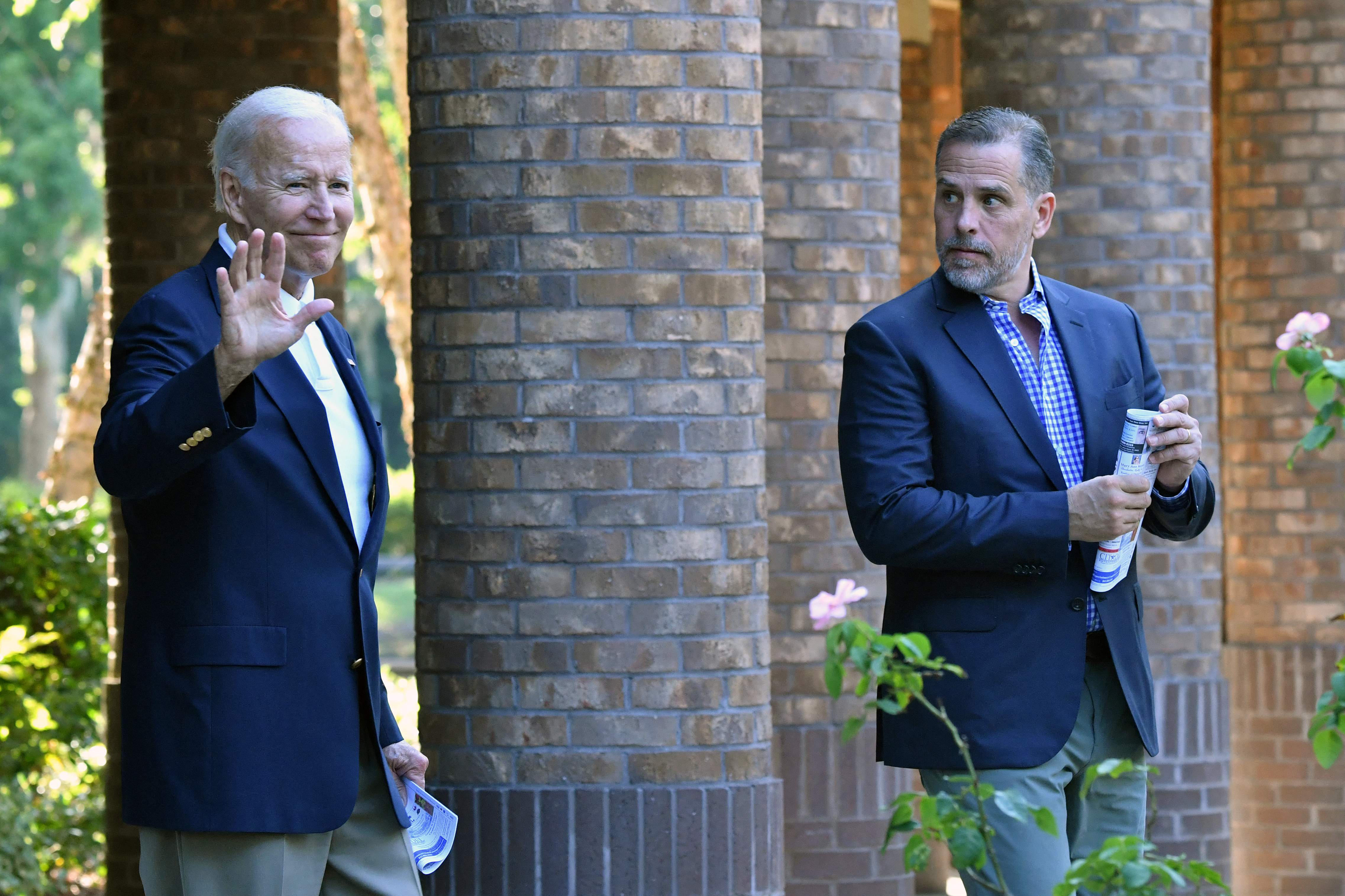 US President Joe Biden (L) waves alongside his son Hunter Biden