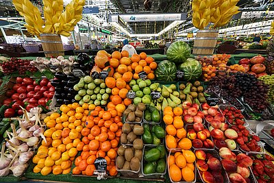 Fresh fruits and vegetables at Russian summer market July 2025, apples, carrots, garlic, berries
