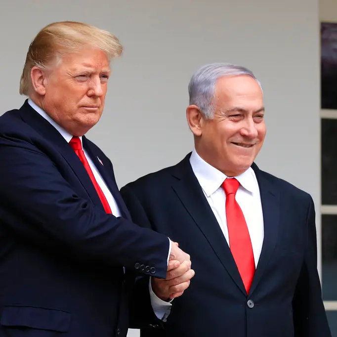 Trump and Netanyahu shake hands during Abraham Accords negotiations amid Gaza genocide