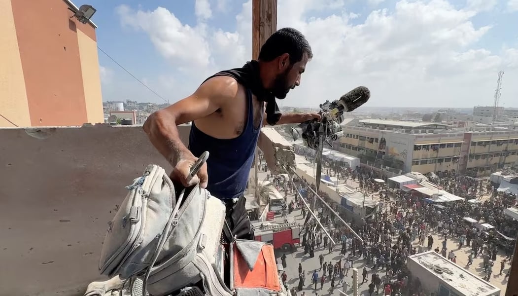 Man holds equipment of Reuters cameraman Hussam al-Masri killed in Israeli strike on Nasser Hospital in Gaza