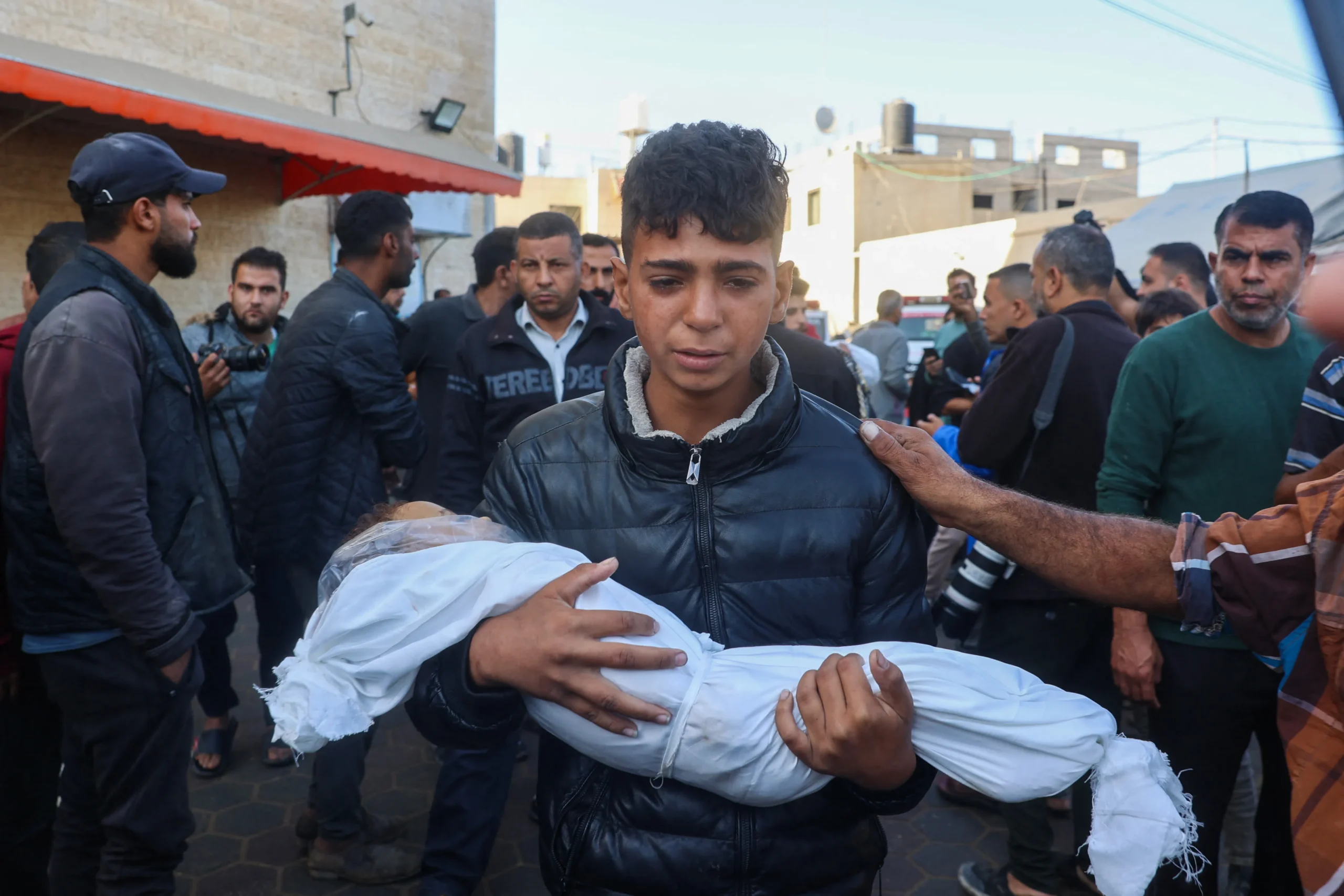 Grieving Palestinian family carries bodies of slain children Nayef and Abdallah Nashwan after Israeli airstrike on al-Zawaydeh, central Gaza