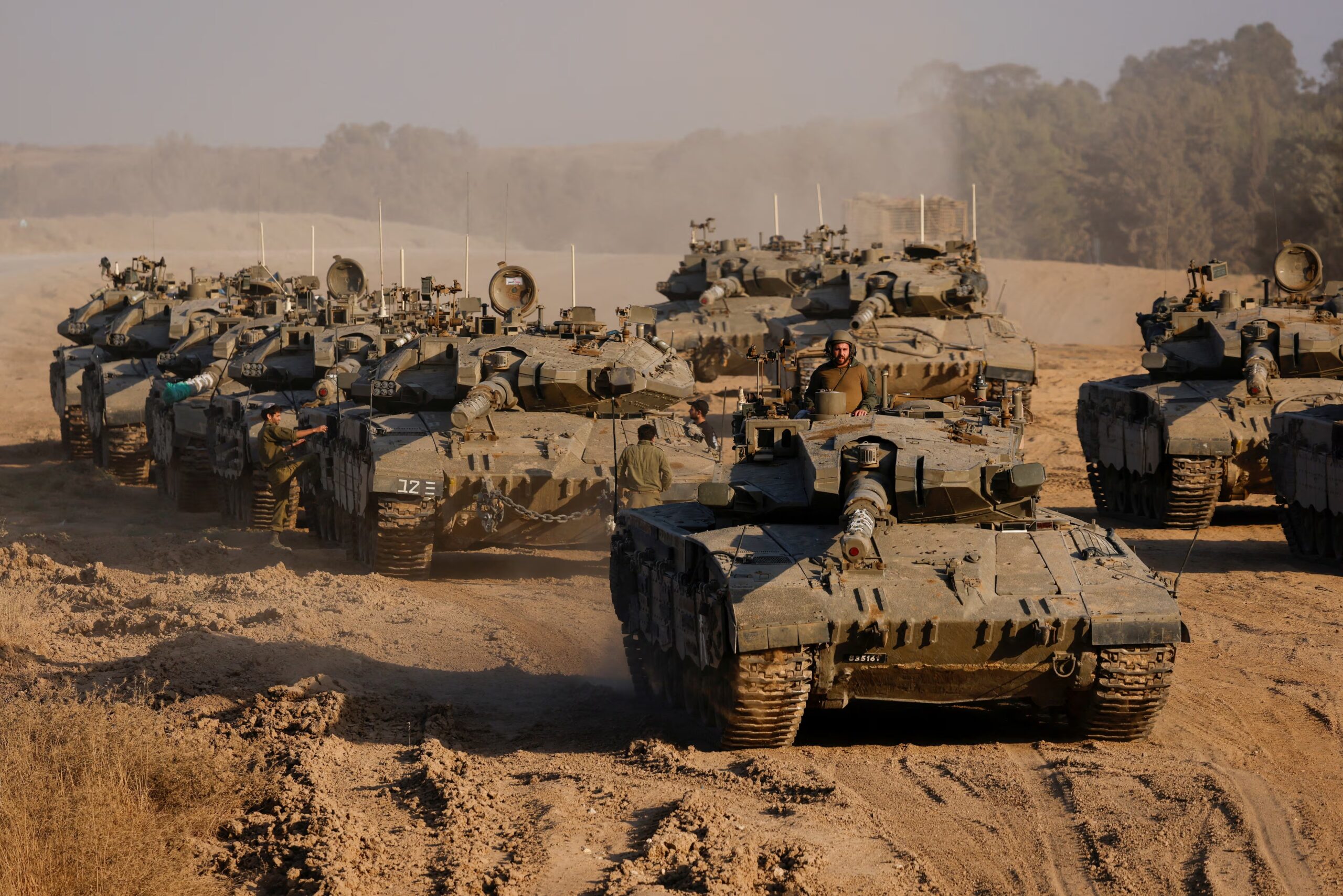 Israeli military vehicles and tanks stationed near Gaza border as occupation plan defies ICJ ruling.