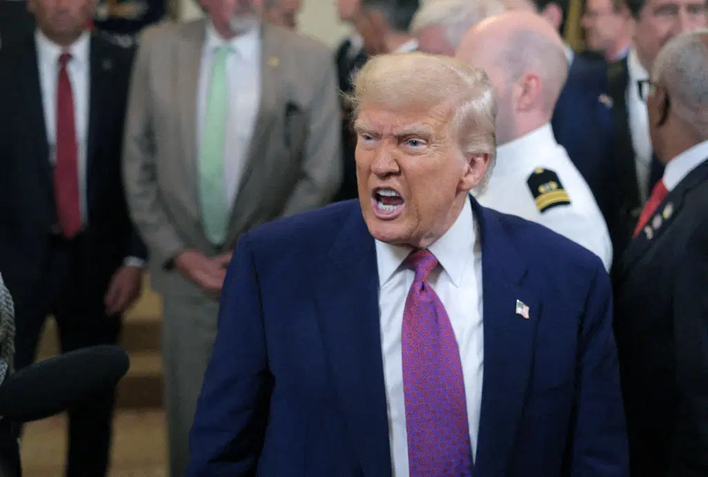 donald trump speaking at a podium demanding intel ceo resignation