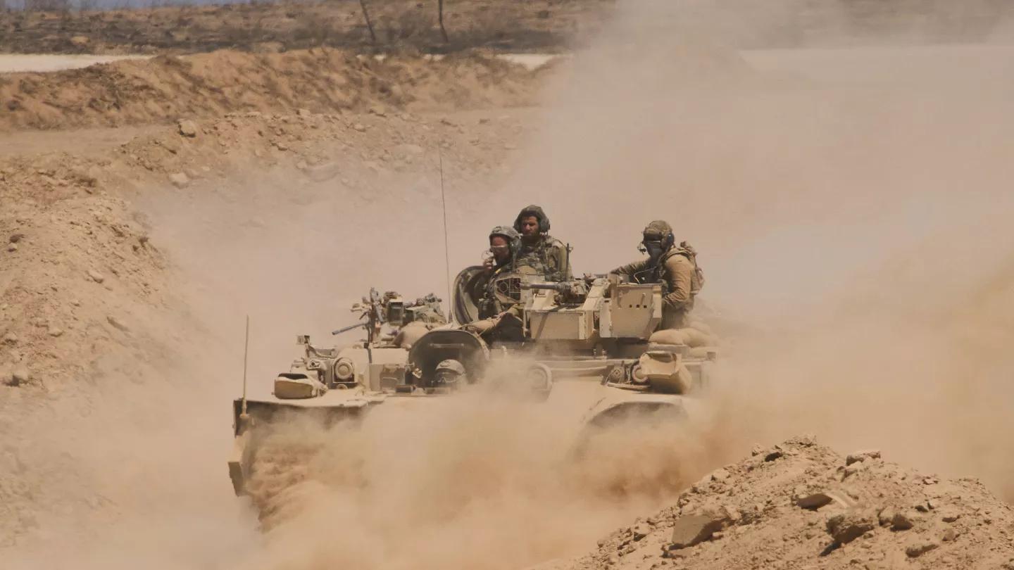 israeli troops and tanks advancing into gaza amid mass civilian expulsions and occupation plans