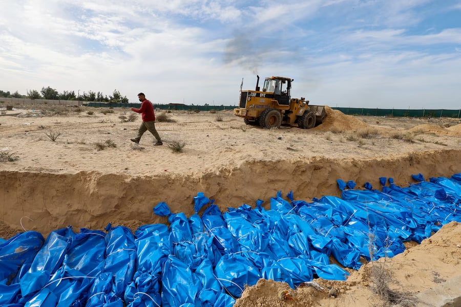 Bodies of Palestinians killed in Israeli strikes buried in a mass grave in Khan Younis after transfer from Al Shifa hospital in Gaza City Bodies of Palestinians killed in Israeli strikes buried in a mass grave in Khan Younis after transfer from Al Shifa hospital in Gaza City