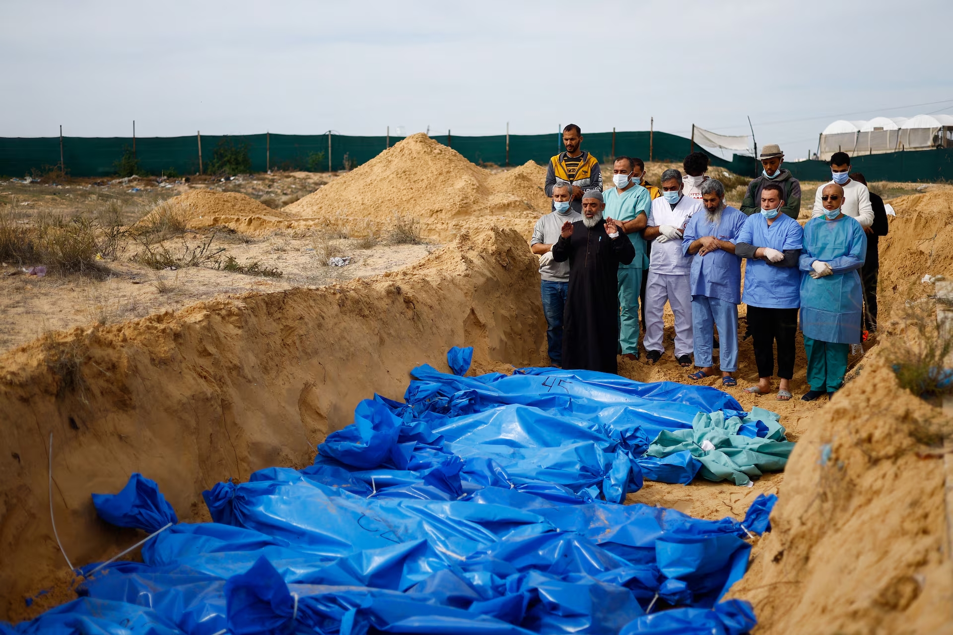 Bodies of Palestinians killed in Israeli strikes buried in a mass grave in Khan Younis after transfer from Al Shifa hospital in Gaza City