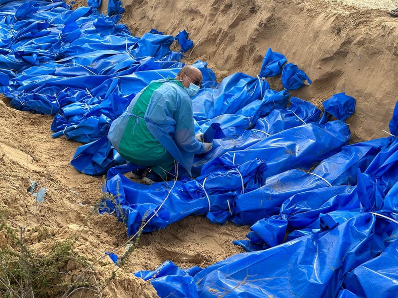 Bodies of Palestinians killed in Israeli strikes buried in a mass grave in Khan Younis after transfer from Al Shifa hospital in Gaza City Bodies of Palestinians killed in Israeli strikes buried in a mass grave in Khan Younis after transfer from Al Shifa hospital in Gaza City