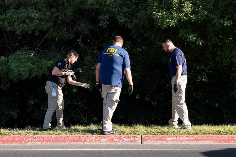 FBI Investigators At UVU Rooftop After Charlie Kirk Shooting FBI and campus police examine a UVU rooftop with cameras and evidence markers after the fatal shooting of Charlie Kirk in Orem, Utah.