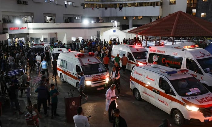 Palestinian families in Gaza hospital crowded around bodies of airstrike victims