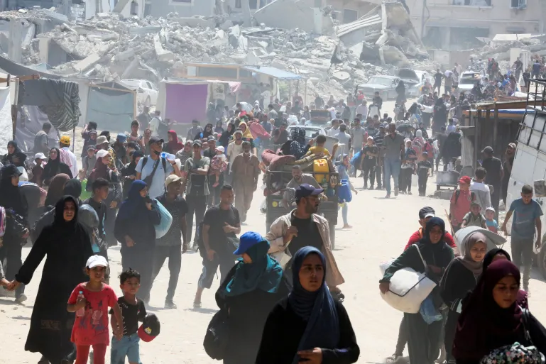 Gaza City buildings burn after Israeli airstrikes amid evacuation and US-backed escalation.