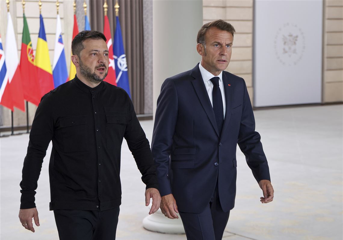 Emmanuel Macron and Volodymyr Zelenskyy at Paris summit announcing postwar security guarantees for Ukraine.
