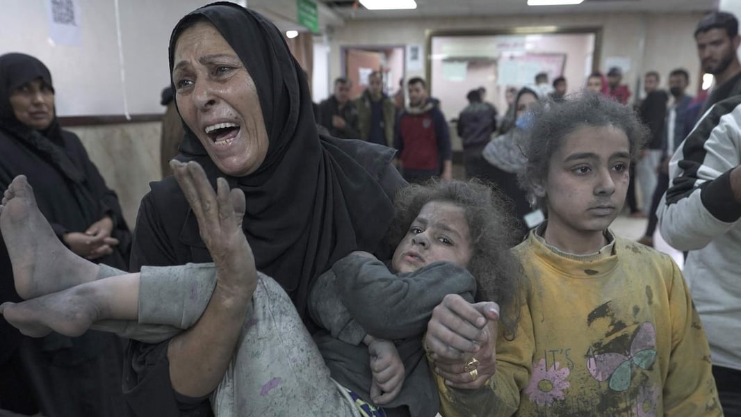 Deir Al-Balah Emergency Ward Amid Renewed Strikes A wounded child is carried through a crowded emergency room at Al-Aqsa Martyrs Hospital in Deir al-Balah.