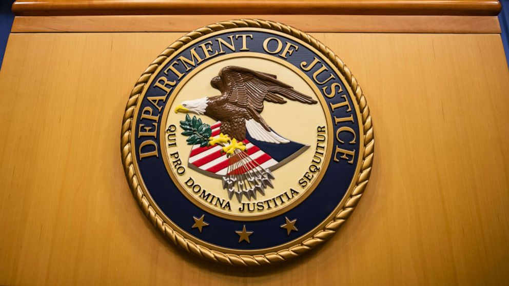 DOJ press podium with the Department of Justice seal