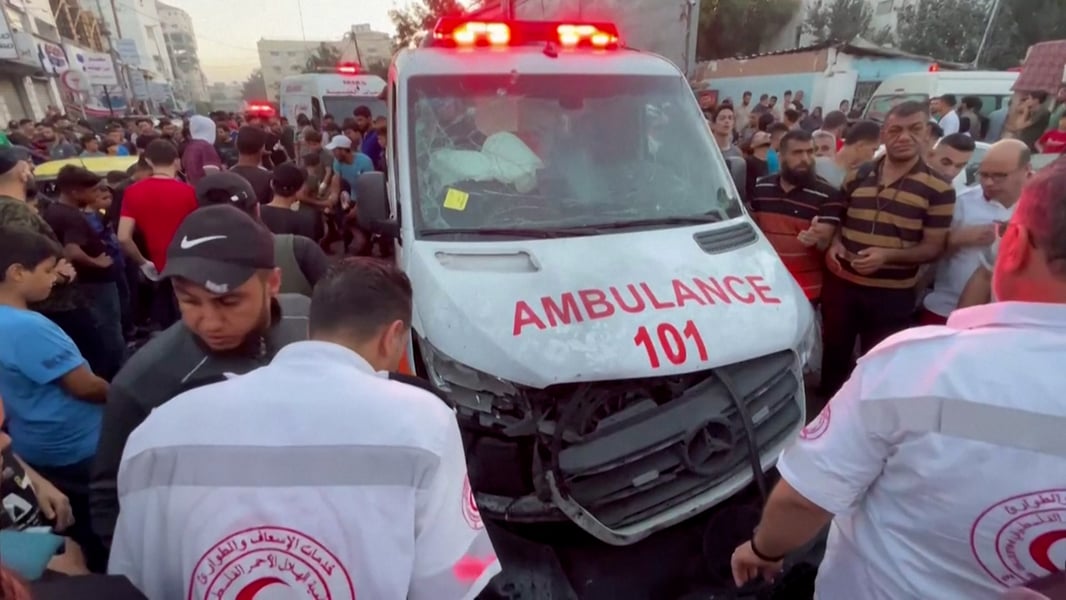 Gaza ambulance with flashing lights outside a shuttered clinic at night